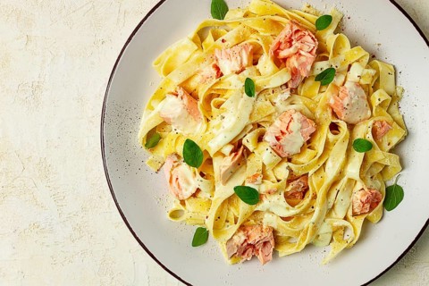 Tagliatelle pasta, in cream sauce with salmon, homemade, no people