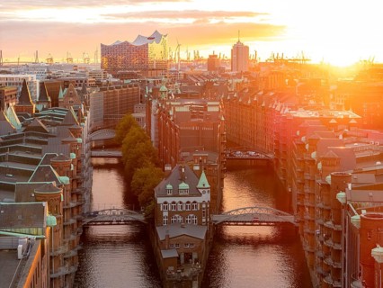 Aerial view of Speicherstadt Hamburg with Fleetschlösschen and Elbe Philharmonic Hall at sunset,