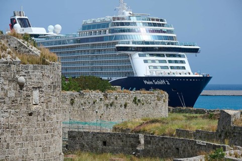 Large cruise ship near an old city wall on a sunny day, TUI, Mein Schiff 2, harbour area, Rhodes