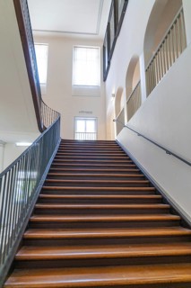 Wooden staircase with strong lighting through high windows, interior design, Kirchheim Teck,