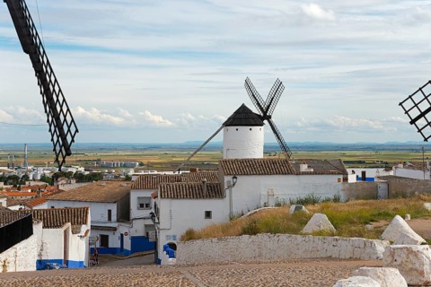 Panoramic view of a village with windmills and white and blue houses, Campo de Criptana, Ciudad