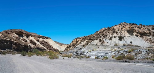 A barren desert landscape with rocky hills and a clear blue sky, La Tortuga, Tabernas Desert,
