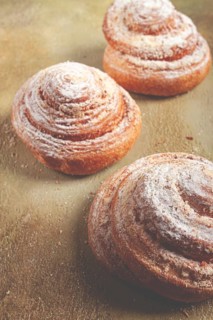 Bakery product, lemon twist, with white glaze, sweet bun, muffin, pastries, top view, no people