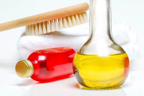 Bottles of bath oil and shampoo, brush and towel, massage oil