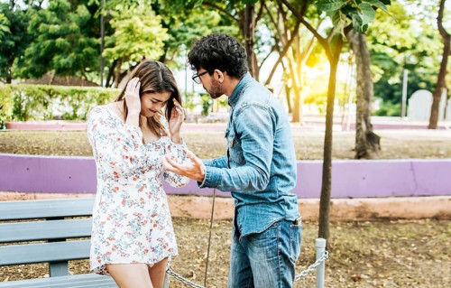 Man and woman arguing in a park. Young couple arguing misunderstanding in a park, Unhappy couple
