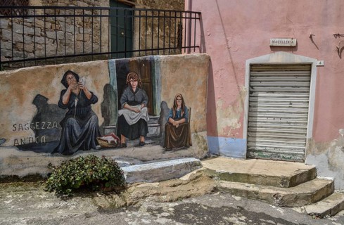 Mural of Sardinian women, village life, artist Pasqualino Baingiu, Orgosolo, Province of Nuoro,