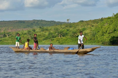 Fisher family on a pirogue on the Congo River, near Tshumbiri, Bandundu Province, Congo, Africa