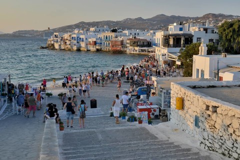 Tourists watching the sunset in Little Venice, Chora or Mykonos Town, Mykonos, Cyclades, Greece,