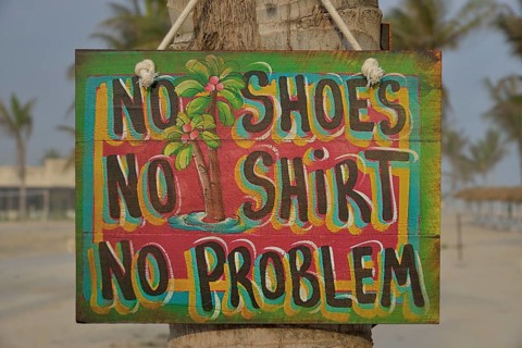 Sign "No shoes, no shirt, no problem" on the beach of Salalah Rotana Resort, Salalah, Dhofar