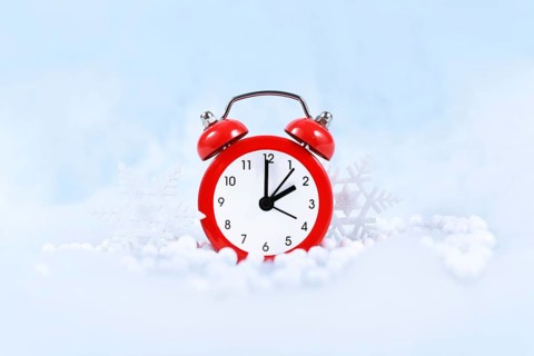 Winter time change for daylight saving in Europe on October 31st concept with red alarm clock