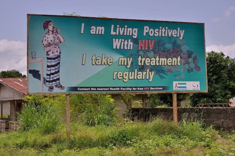 Sign with the inscription "I am living positively with HIV", near Koidu, Kono District, Eastern