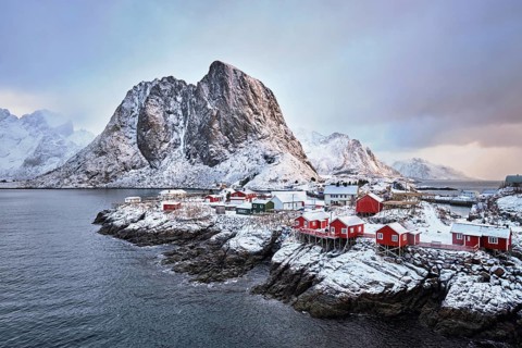 Famous tourist attraction Hamnoy fishing village on Lofoten Islands, Norway with red rorbu houses