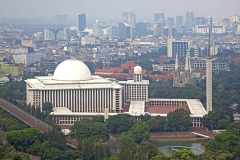 Smog hanging over Jakarta and view over the Istiqlal Mosque, Masjid Istiqlal, largest mosque in