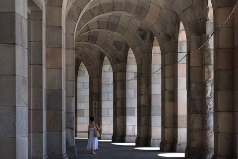 Lady in a white dress in the arcade of the Congress Hall, unfinished National Socialist monumental