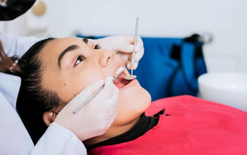 Close up of a dental specialist cleaning a patient's teeth. Close up of professional dentist