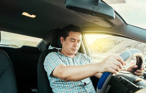 View of a driver asleep at the wheel. Tired driver with closed eyes at the wheel, concept of man