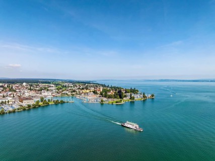 Harbour area, ferry port, yacht harbour, marina of Romanshorn with Seepark and the departing ferry