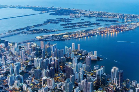 Aerial view of Miami skyline with skyscrapers Downtown Brickell and Miami Beach at night in Miami,