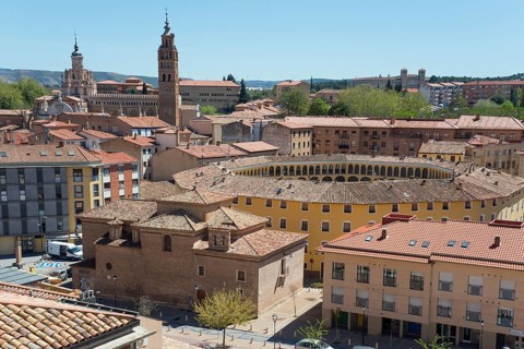 Panorama of a city view with a characteristic round building and a church tower in the background,