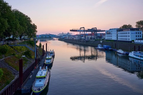 Vincke Canal with container bridge of duisport, Duisburger Hafen AG at sunrise in Ruhrort,