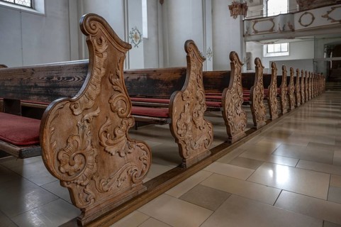 Historic, wood-carved cheeks of church pews, Heilig Kreuz Minster, Rottweil, Baden-Württemberg,