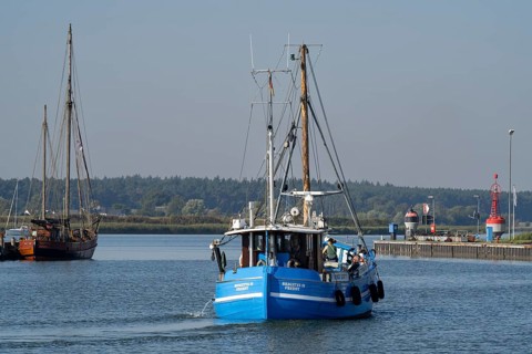 Fishing boat in the harbour entrance at the Peenestrom, Baltic resort Karlshagen, Island Usedom,