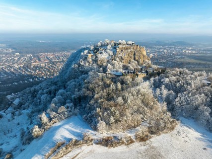 Aerial view of the snow-covered Hegau volcano Hohentwiel with Germany's largest castle ruins,