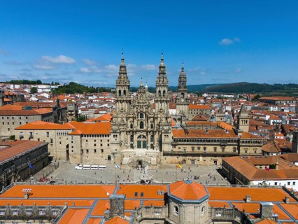 An impressive aerial view of a historic cathedral with red roofs on a sunny day, Cathedral,
