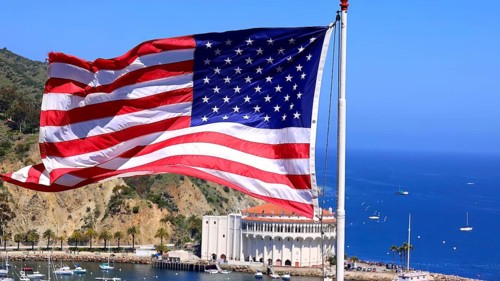 American star spangled flag waving in California. A large American flag is flying high above