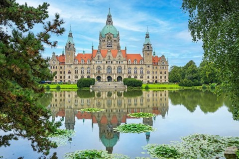 New town hall on Trammplatz with reflection in the Maschteich Hanover Germany