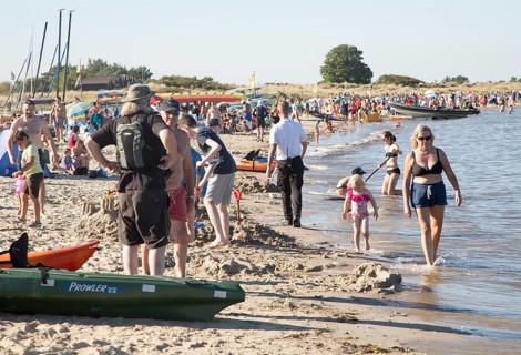 Late afternoon crowded summer sandy beach, Studland Bay, Swanage, Dorset, England, UK