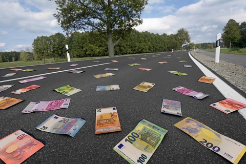 Symbolic image on the subject of subsidies, waste of money, money for road construction, etc