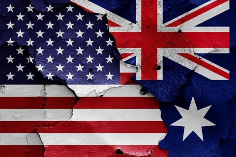 Flags of USA and Australia painted on cracked wall