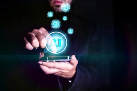 Close up of businessman hand holding mobile phone with creative AI hologram
