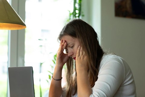 Young woman suffers from burnout in home office on laptop, Freiburg, Baden-Württemberg, Germany,