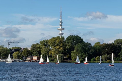Leisure activities in summer, sailing boats against a blue sky on the Alster, TV tower Telemichel