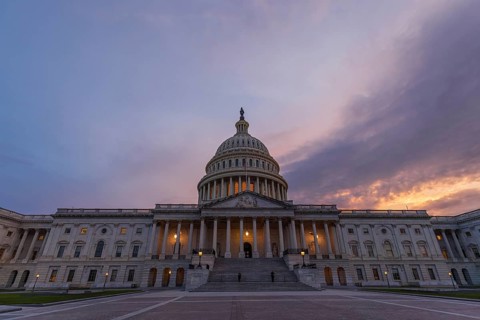 Violet sunset sky over the US Capitol building dome