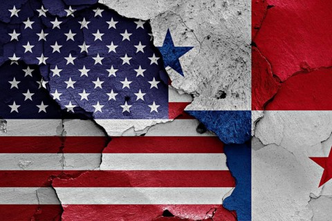 Flags of USA and Panama painted on cracked wall