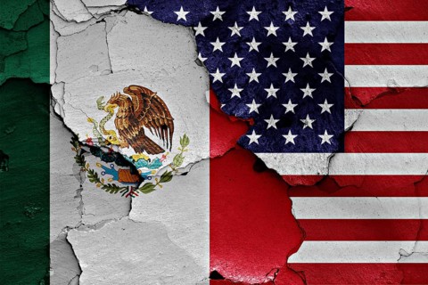 Flags of Mexico and USA painted on cracked wall