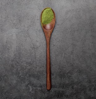 Flat lay matcha tea powder wooden spoon