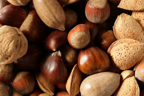 Nuts mix, walnuts, pecam hazelnut, almond, chestnut, crop texture background