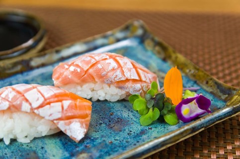 Plate with two elegant nigiri sushi (nigirizushi) with diamond-shaped knife cuts