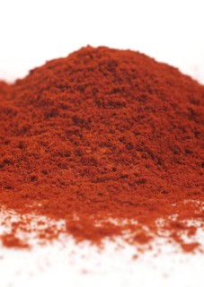 PAPRIKA POWDER AGAINST WHITE BACKGROUND
