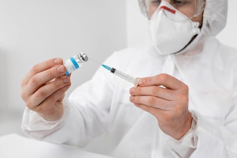 Close up doctor holding covid vaccine