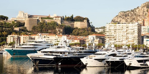 Monte Carlo, Monaco, August 2022: Port Hercule with luxury yachts, boats, and scenery skyline,