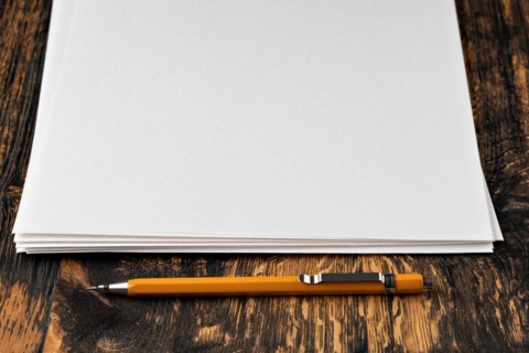 Blank paper with mechanical pencil on wood table