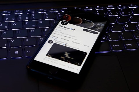 Symbolic image social media, close-up of a smartphone on illuminated computer keyboard with X logo