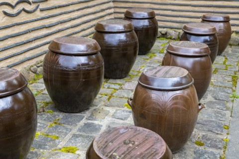 Traditional clay storage jars for soya sauce, tofu, kimchi in the courtyard of a Korean house,