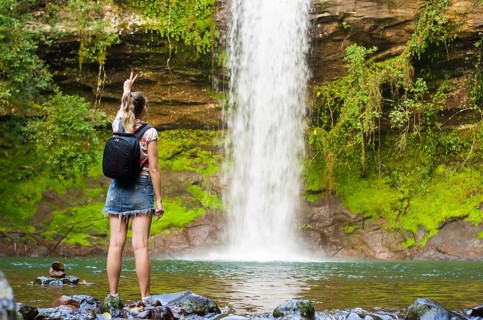 Jung woman in front of waterfall, Maquine, Rio grande do sul, Brazil, South America