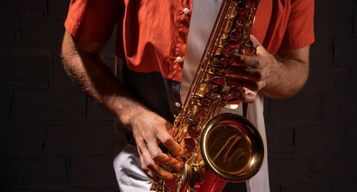 Front view man playing saxophone
